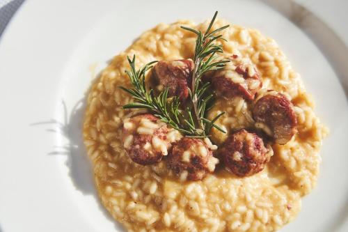a white plate of food with meatballs and beans at Hotel Mondolé - Azzurro Club in Prato Nevoso