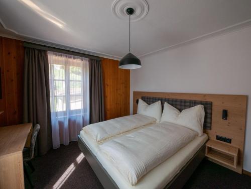 Postel nebo postele na pokoji v ubytování Hotel Restaurant Rätia