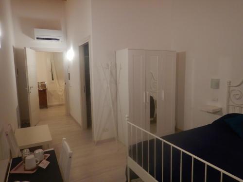 a living room with a bed and a room with a staircase at Ca' Vascon Alloggio Agrituristico in Villa Estense