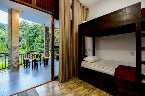 a bedroom with a bunk bed and a balcony at Dolagawa in Deniyaya