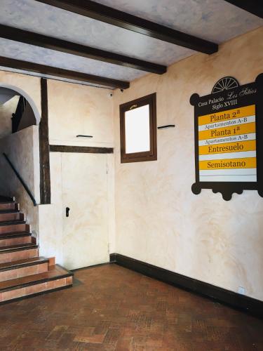 a room with a staircase and a sign on the wall at Casa Palacio de los Sitios in Zaragoza