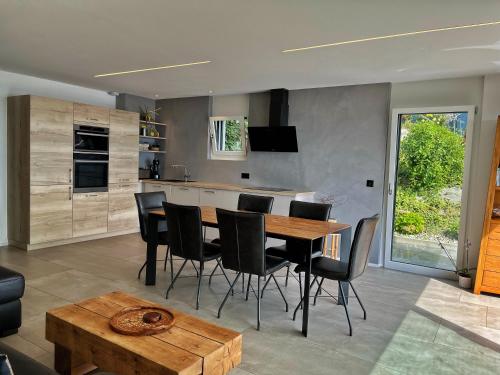 a kitchen and dining room with a table and chairs at Appartement 180 degrés de rêve à Jongny in Jongny