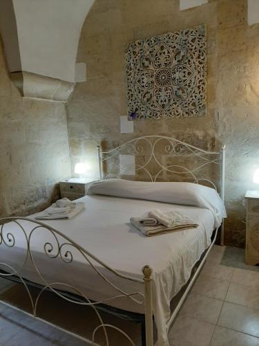 a bedroom with a bed with a metal headboard at Il Vico in Lecce