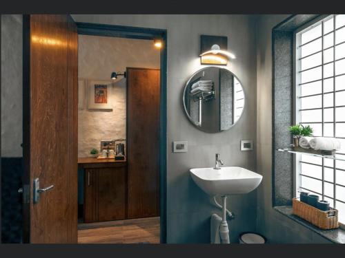 a bathroom with a sink and a mirror at Kalangan Farms By Spicy Mango in Alibaug