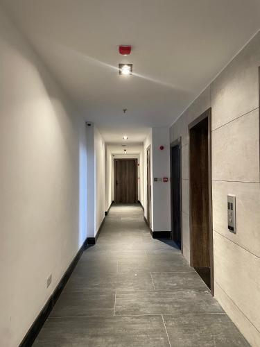 an empty hallway with a hallway leading to a door at Sincerely Yours Suites & Serviced Apartments in Nairobi