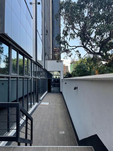 an empty hallway in a building with a tree at Sincerely Yours Suites & Serviced Apartments in Nairobi