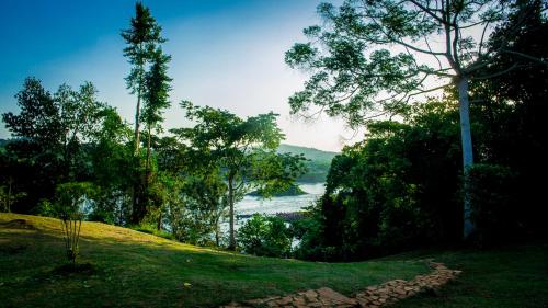 a grassy hill with a view of a body of water at Buyala Bliss on the Nile in Jinja