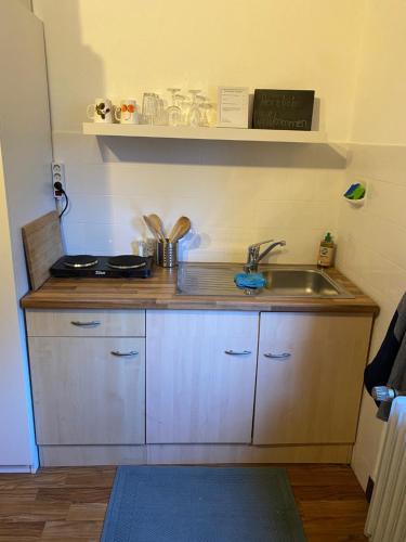a kitchen with a sink and a counter top at Kleines Apartment in Siegburg-Kaldauen in Siegburg