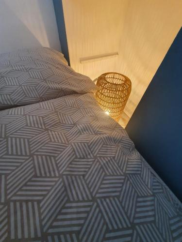 a bedroom with a bed with a lamp on it at APPARTEMENT HYPER CENTRE - Place du Minage in Angoulême