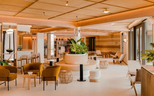 a lobby of a hotel with chairs and tables at Aethos Ericeira in Ericeira