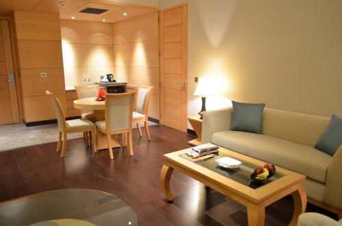 a living room with a couch and a table at The Umrao in New Delhi