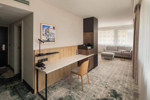 a lobby with a desk and a chair in a room at Crowne Plaza Budapest by IHG in Budapest