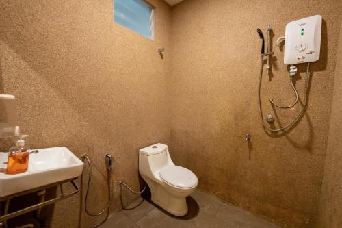 a bathroom with a shower and a toilet and a sink at Mary J Hotel Family 10 pax room in Kota Bharu