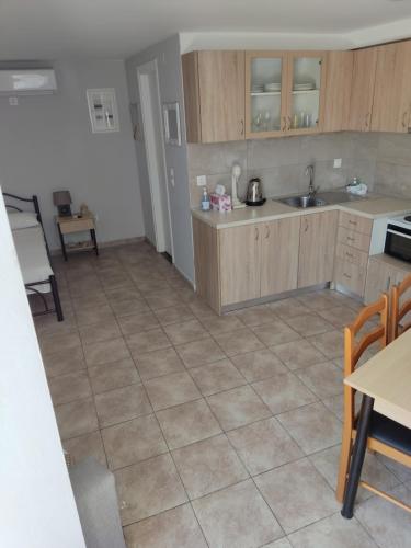 a kitchen with a tiled floor and a sink at Silvia's Apartments in Corfu Town