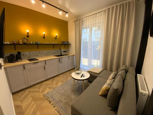 a living room with a couch and a table at Salt Garden Superior double rooms in Druskininkai