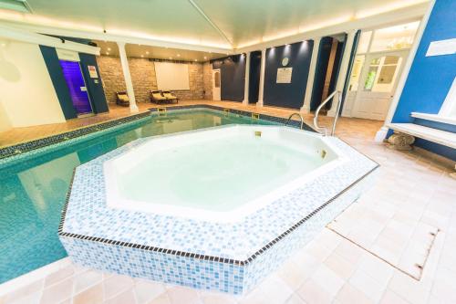 a large swimming pool with a tub in the middle at Grange Hotel in Grange Over Sands