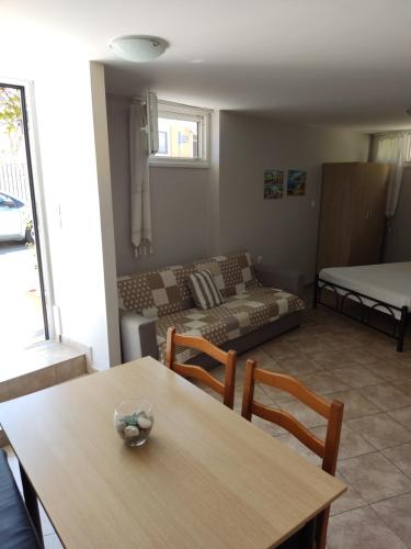 a living room with a table and a couch at Silvia's Apartments in Corfu Town