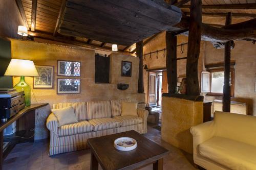 a living room with two couches and a table at Dimora Migliori in Viagrande