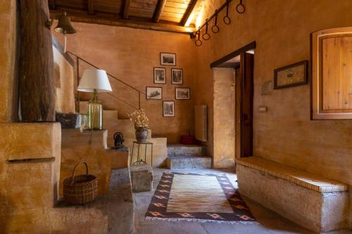 a hallway with stairs and a table and a lamp at Dimora Migliori in Viagrande