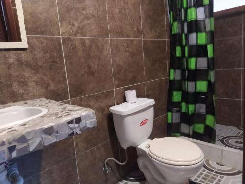 a bathroom with a toilet and a sink at Grand Selva Lodge & Tours in Tena