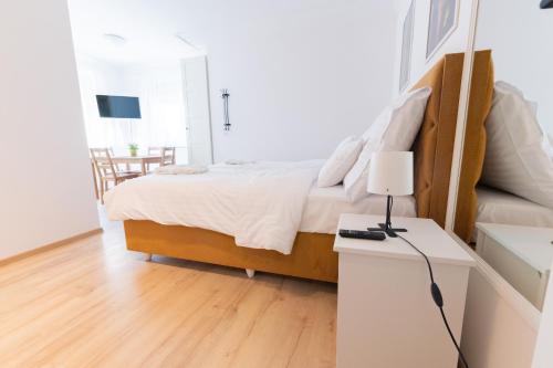 a bedroom with a bed and a table with a lamp at Villa Lilith Smart in Fertőrákos