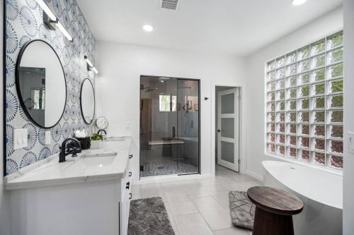 a bathroom with a sink and a tub and a mirror at Amazing Luxury Home with Hot Tub & Views in Sedona