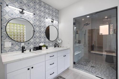 a bathroom with a shower and a sink and a mirror at Amazing Luxury Home with Hot Tub & Views in Sedona