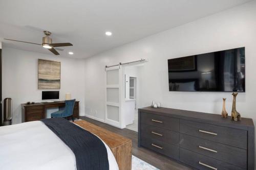 a bedroom with a bed and a desk and a tv at Amazing Luxury Home with Hot Tub & Views in Sedona