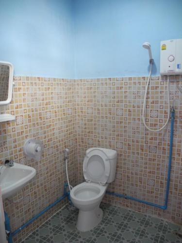 a bathroom with a toilet and a shower at Nam Pueng Place 2 in Chiang Saen