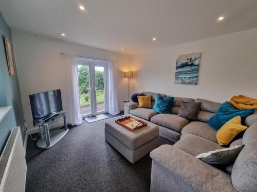 a living room with a couch and a tv at No.2 Bloom Apartments, Bath in Bath