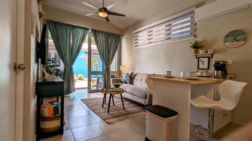 a kitchen and living room with a couch and a table at Villas at Chalet De Buye in Cabo Rojo