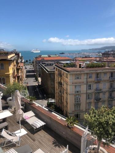 a view of a city with chairs and buildings at Casa Palmira in La Spezia