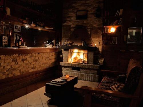 a bar with a fireplace in a room at Pirola Music Ranch Guest House B&B in Romano di Lombardia