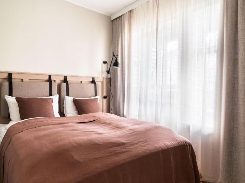 a bedroom with a large bed and a window at 46heima Boutique Apartments in Reykjavík