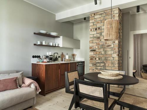 a living room with a table and a kitchen at 46heima Boutique Apartments in Reykjavík