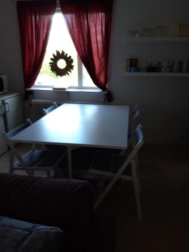 a table and chairs in a living room with a window at The Old Post Office in Hedenäset