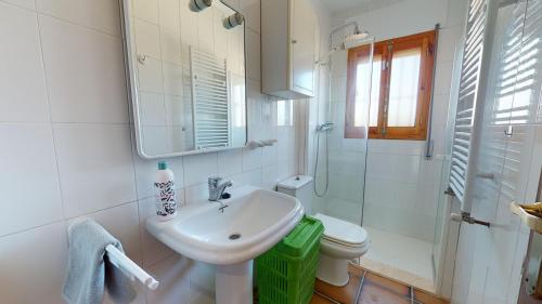 a bathroom with a sink and a toilet and a mirror at Villa Desamparados-Murcia Holiday Rentals Property in Torre-Pacheco