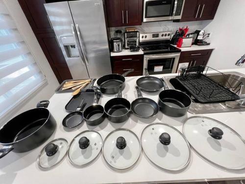 a kitchen with pots and pans on a stove at Vacay Spot experience Luna Sky! 65" TV BAR, BBQ, SHOWER massage jets, music, go to FL Keys in Homestead