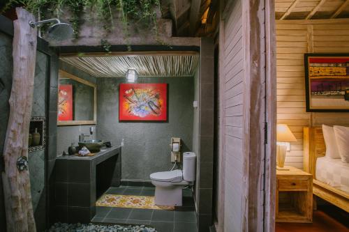 a bathroom with a toilet and a sink at Aget Private Villas in Toyapakeh