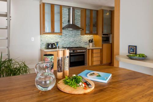 a kitchen with a wooden table with a plate of food at Infinity Villa in Knysna