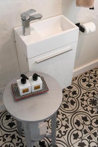 a bathroom with a sink and a table at Infinity Villa in Knysna