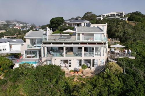 a large white house on top of a hill at Infinity Villa in Knysna