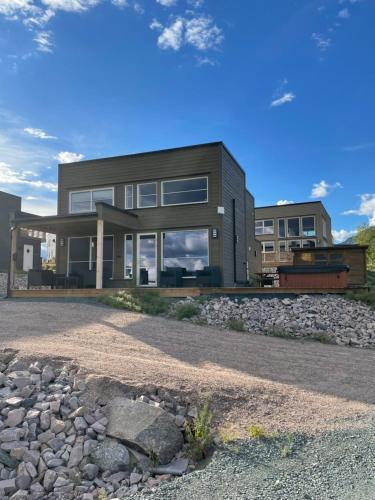 a rendering of a house with a stone driveway at Exclusive Funkis Cabin, Lake View, Rooftop Terrace, Jacuzzi, Sauna, Close to Golf and Alpine in Vradal