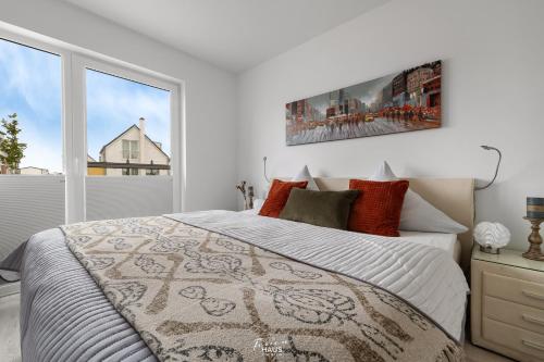 a bedroom with a bed and a large window at Strandhaus Ambiente 2 in Olpenitz
