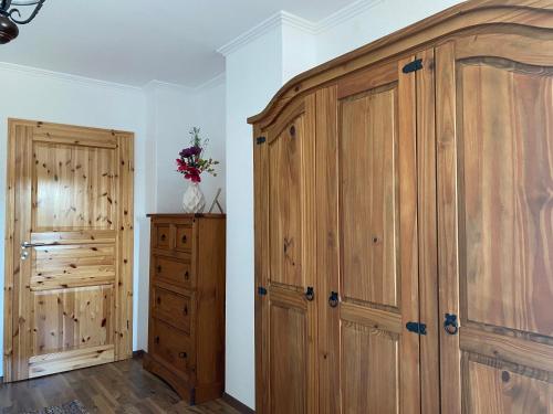 a bedroom with a large wooden closet and a cabinet at Unter dem Dach mit Parkplatz in Bremen