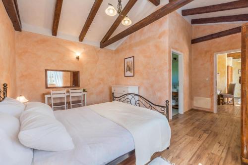 a bedroom with a white bed in a room at Beautiful villa Natura with pool in Labin in Labin