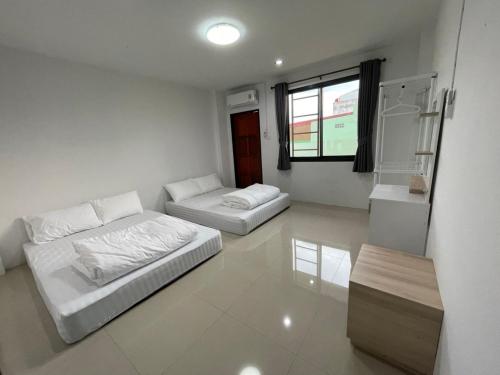 a living room with two beds and a couch at Khoksametchun Hostel in Hat Yai