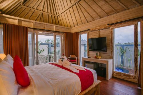 a bedroom with a bed and a tv and windows at Aget Private Villas in Toyapakeh