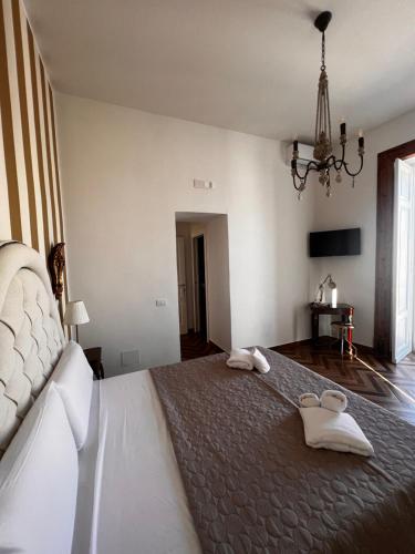 a bedroom with a large bed with towels on it at Villa Valminuta in Ercolano
