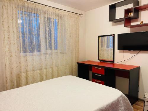 a bedroom with a bed and a flat screen tv at Casa Iris in Iaşi